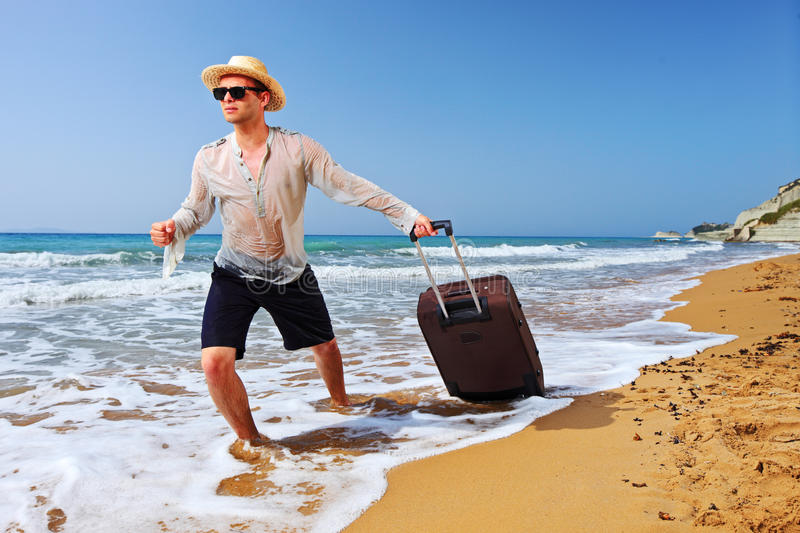 tourist-carrying-suitcase-beach-14825632